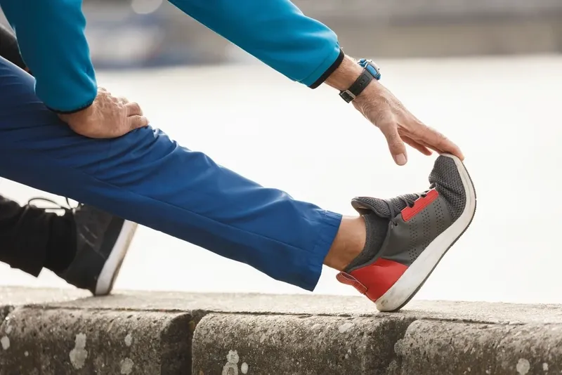 Someone stretching a leg before a run